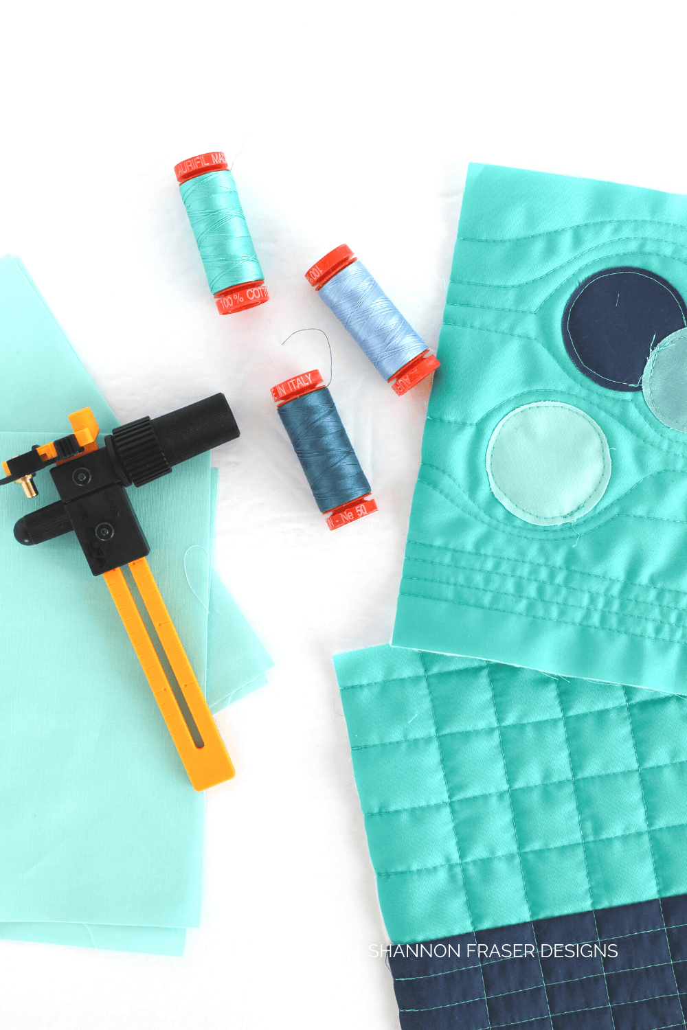 Pale Blue Dot Zip Pouch by Shannon Fraser Designs for the Slice and Stitch Challenge hosted by Aurifil Thread and Olfa. This one was all about diving into raw edge appliqué circles and adding all the quilty texture with 50wt thread - sew fun! #rawedgeapplique #zippouch