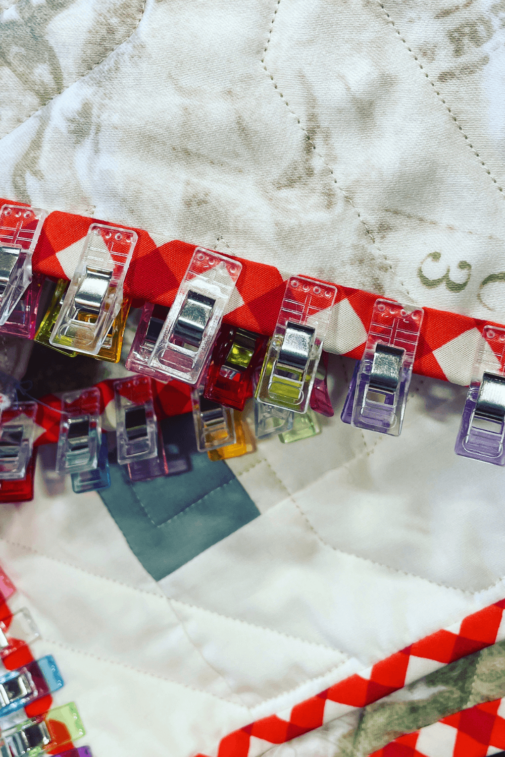 Close up of the binding clips Cheryl of Meadow Mist Designs uses while hand binding her quilts. See all the notions she stocks in her sewing kit over on Shannon Fraser Designs' blog as part of the What's in Your Sewing Bag series #whatsinyoursewingbag #binding #quilting
