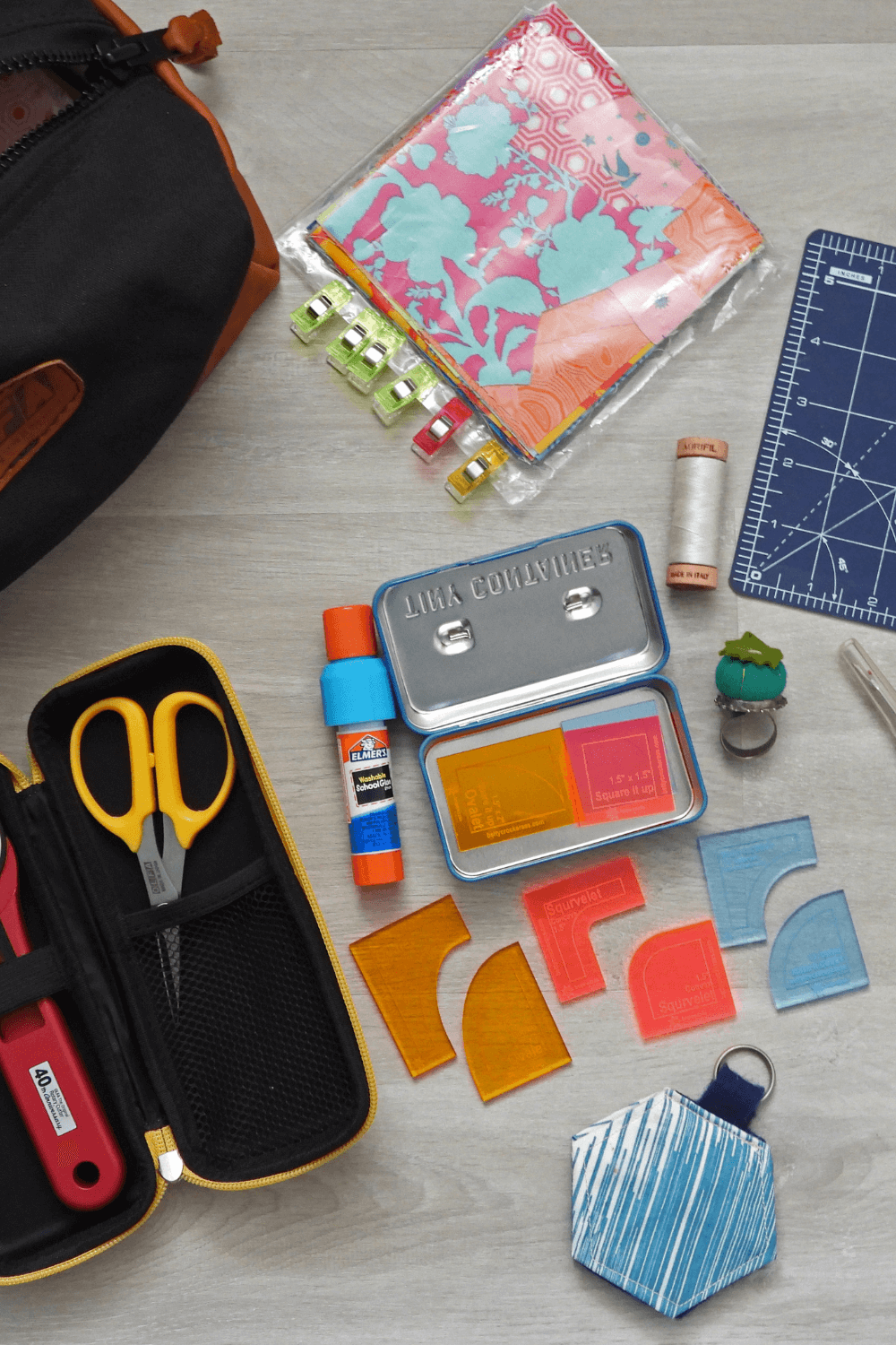 Contents of Quilting Jetgirl's sewing bag strewn on a table as part of the What's in Your Sewing Bag Series hosted by Shannon Fraser Designs See more on the blog #quiltblog #sewing #sewingkit