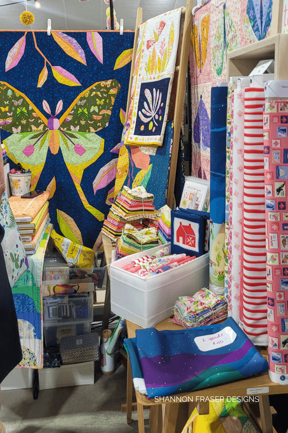 Explore the vibrant vendor booths at Twist Fiber Festival—hand-dyed yarns, natural fibers, and artisan tools for every crafter. Shown here is Tamara Kate Design's booth. #twistfiberfestival #quilting #fiberart