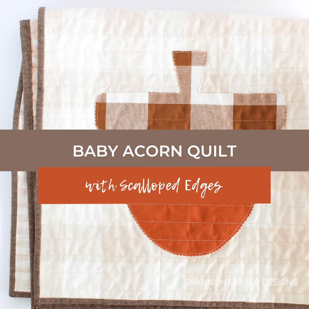 Cozy up with this fall-inspired baby quilt! Featuring raw-edge appliqué acorns and gingham fat quarters, made with the Cake Stand Quilt Pattern.